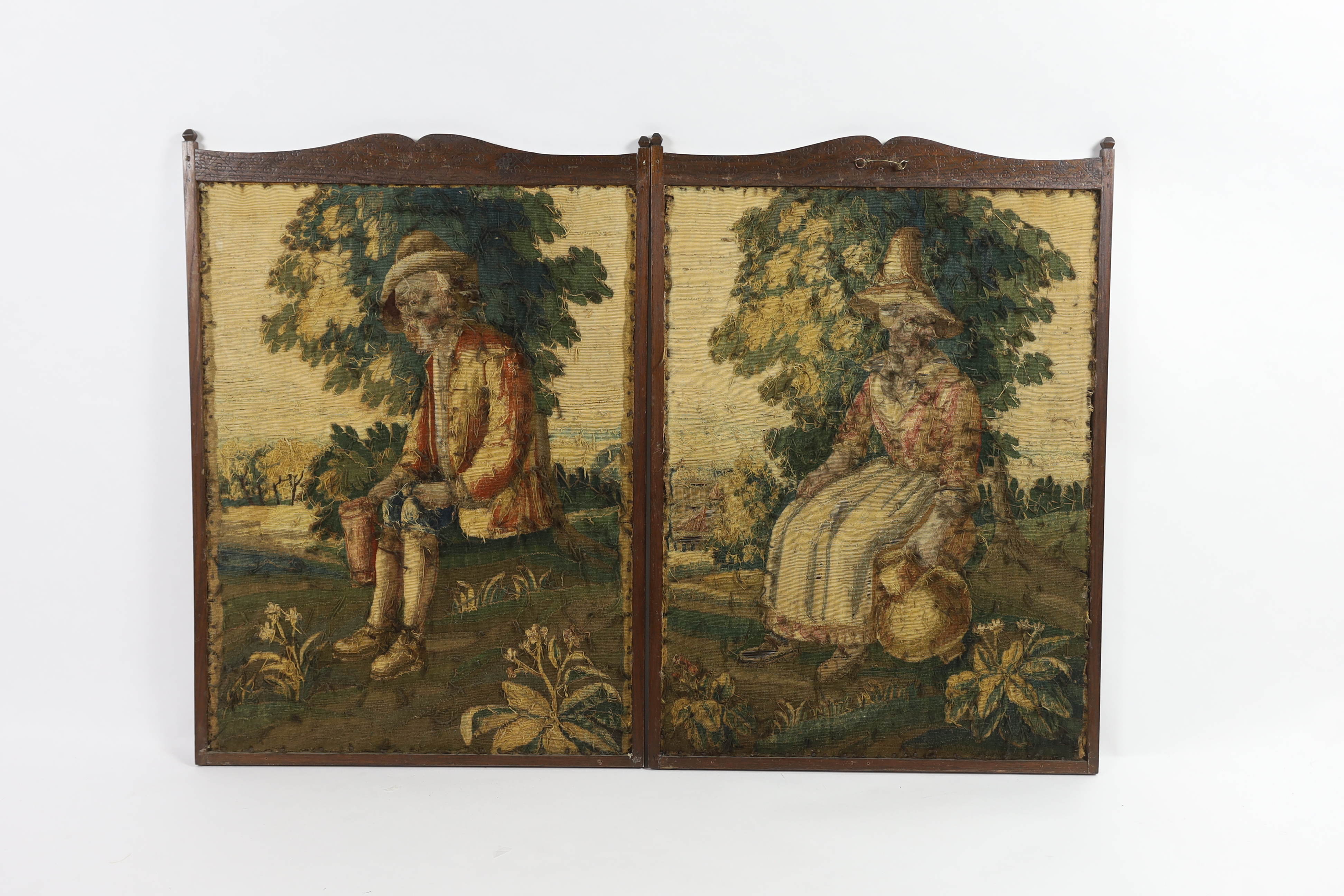 Two 18th century Brussels verdure tapestry panels, one of a seated peasant lady holding a flagon and the other a similar gentleman holding a large tankard, surrounded by lush green landscape, probably part of a larger ta